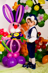 Cute baby in balloon forest