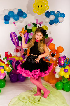 Beautiful little girl in balloon forest