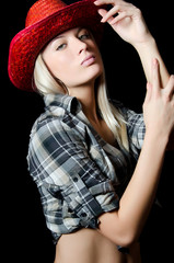 The beautiful girl in a cowboy's hat isolated