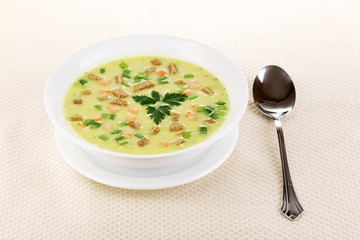 Tasty soup on beige tablecloth isolated on white