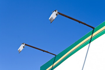 Two spot lights poles on billboard