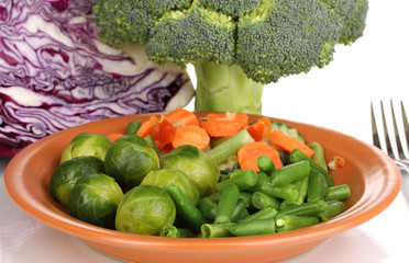 Mixed vegetables on plate close-up isolated on white