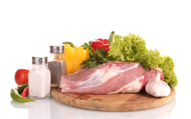 Raw meat and vegetables on a wooden board isolated on whitе