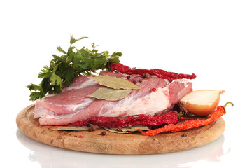 Raw meat and vegetables on a wooden board isolated on whitе