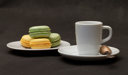 Cup coffee espresso and macaroon closeup on black