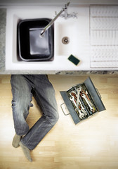 plumber under kitchen sink