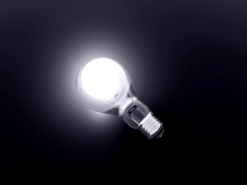 luminous bulb lies on a dark background