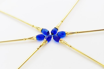 Crystals are dark blue on gold spoons