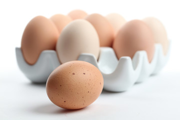 Ceramic egg holder with one brown chicken eggs