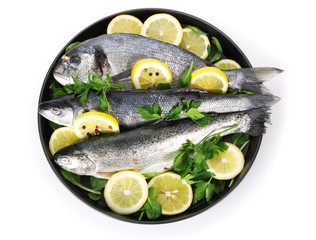 Fresh fishes with lemon, parsley and pepper