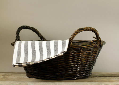 an empty wicker basket on a gray background