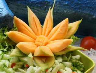 Zelfklevend Fotobehang Cucumber salad decorated with flower curved in melon © Danuta Kania