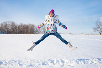 Outdoor winter portrait of beautiful smiling young girl