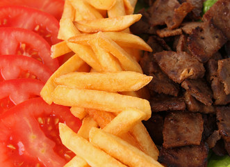close up on meat,fries and tomato