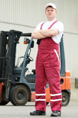 Fototapeta na wymiar warehouse worker in front of forklift