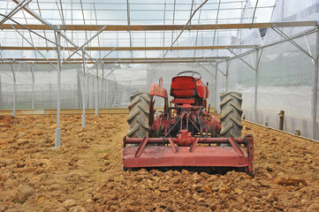 Tractor At A Farm Preparing Soil For Planting
