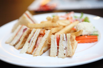Club sandwich with coffee on wood background