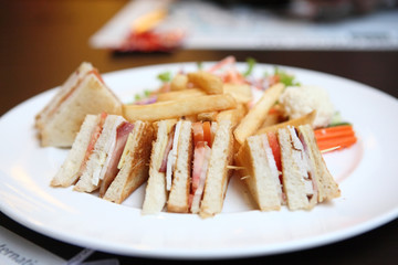 Club sandwich with coffee on wood background