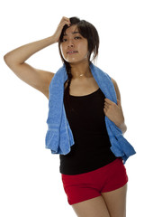 Pretty young Asian woman with towel after fitness
