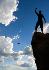 Man on peak of mountain.