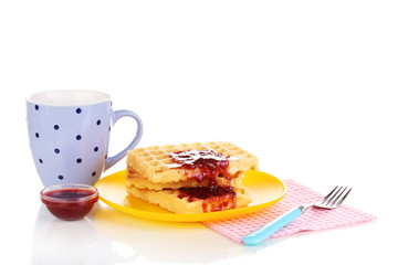 Tasty waffles with jam on plate isolated on white