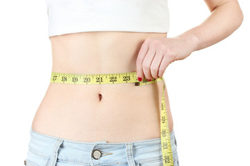beautiful female abdomen and measuring tape