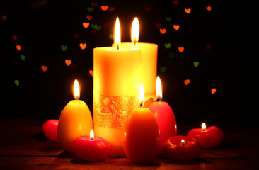 Beautiful candle and decor on wooden table on bright background