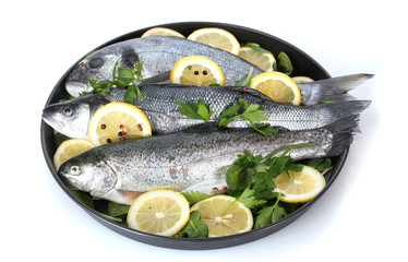 Fresh fishes with lemon, parsley and pepper