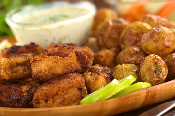 Breaded fried calamary pieces with baked potatoes