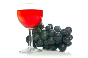 Red wine in glass with grape