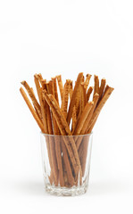 crispy bread straw in a glass on a white background.