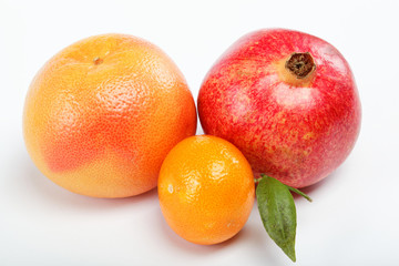 pomegranates and citrus fruits isolated on a white background.
