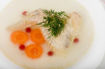 Tasty chicken clear soup with hen wing in plate
