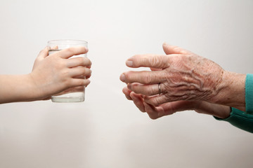 grandmother and grandchild with the glass of water