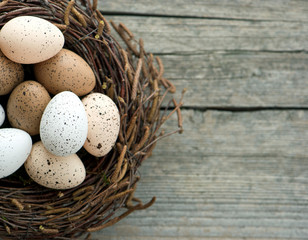 Naklejka na ściany i meble nest with eggs on wooden background