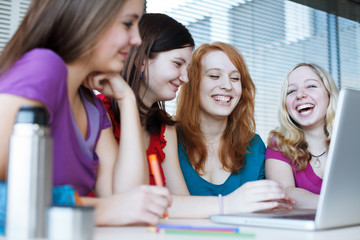 Four female college students working on their homework