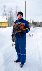 The worker-electrician  in blue overalls