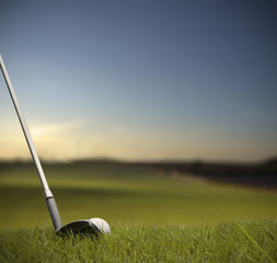 hitting golf ball with club