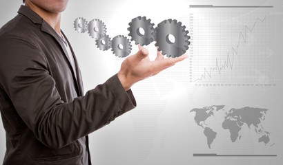 Businessperson holding gears of success in hand