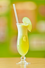 Freshly squeezed apple juice served in a hurricane glass with st