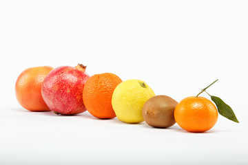 pomegranates and citrus fruits isolated on a white background.
