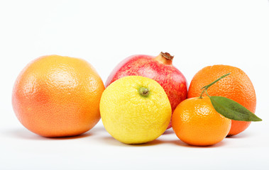 pomegranates and citrus fruits isolated on a white background.