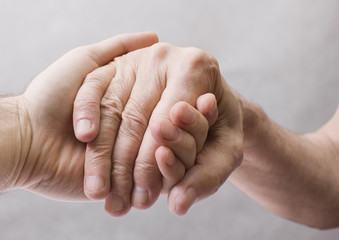 Young hand give help to old hand