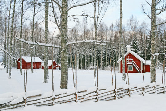 Swedish winter landscape with red wooden houses