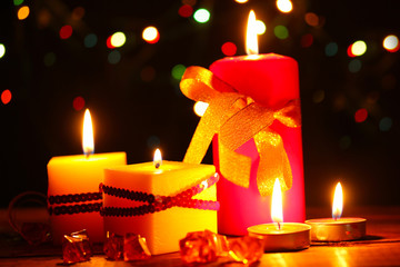 Wonderful candles on wooden table on bright background