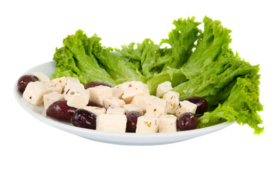 feta cheese with olives and lettuce on a plate