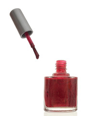 Nail varnish aka polish with brush over white