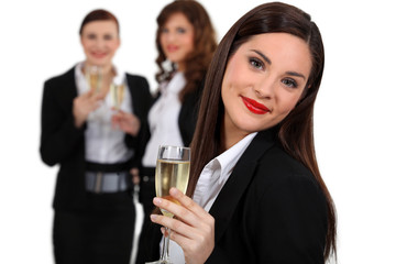 Business women drinking champagne