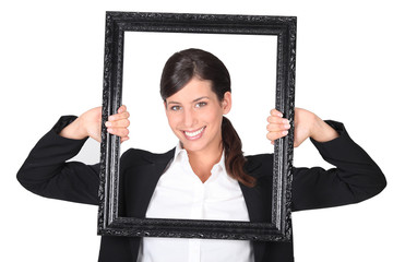 Woman holding empty art frame