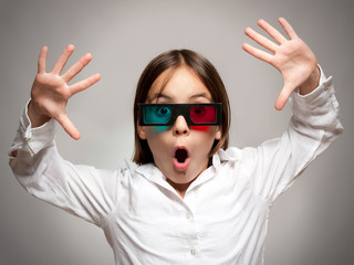 little girl with 3d glasses a watching movie